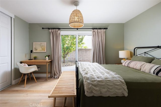 bedroom featuring light hardwood / wood-style flooring and access to outside