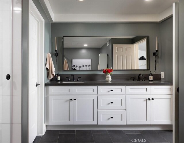 bathroom with tile patterned floors and vanity