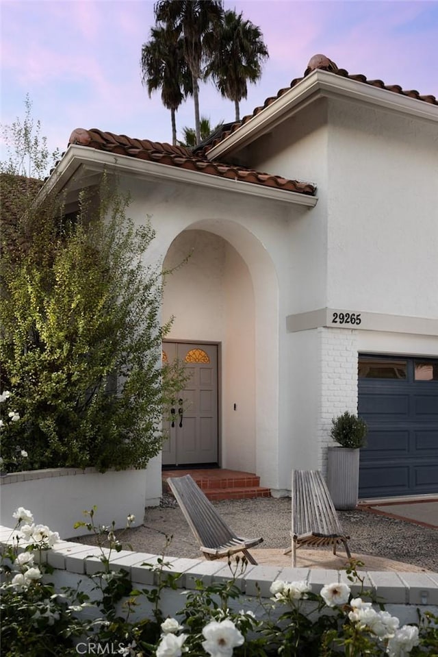 exterior entry at dusk with a garage