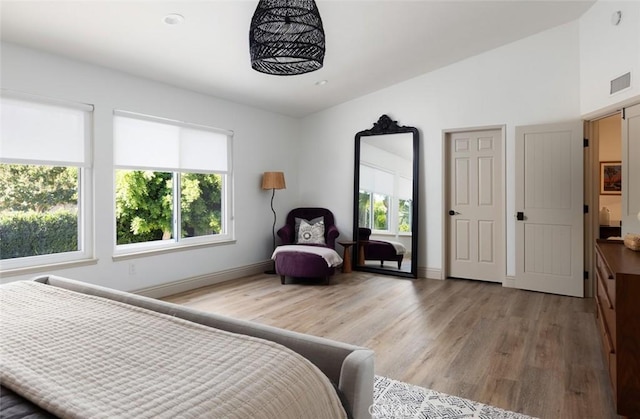 bedroom featuring hardwood / wood-style floors and multiple windows