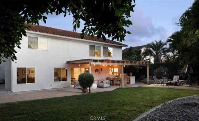 back of house featuring a yard and a patio