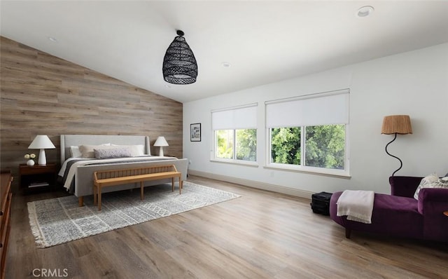 bedroom with hardwood / wood-style floors and lofted ceiling