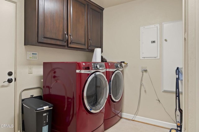 clothes washing area featuring cabinets, light tile patterned floors, electric panel, and washing machine and clothes dryer