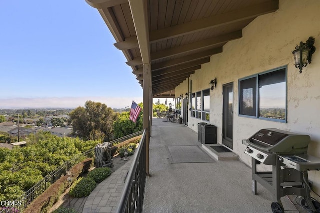 view of patio with a grill and a balcony