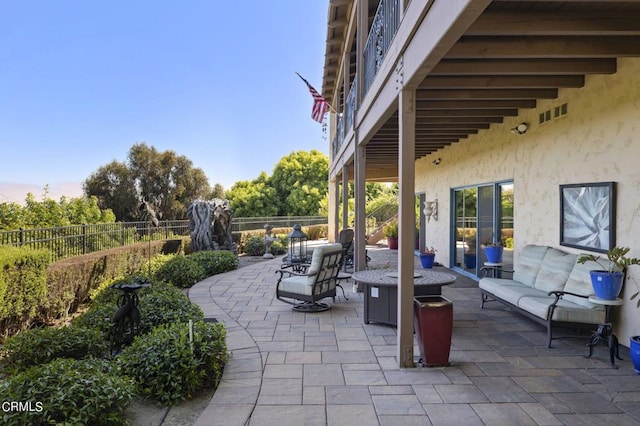 view of patio featuring an outdoor living space and a balcony