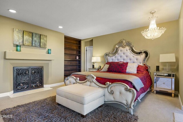 bedroom featuring carpet and a notable chandelier