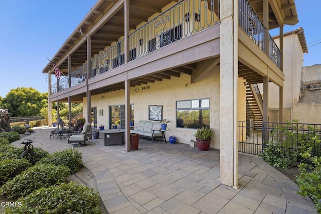 view of patio featuring outdoor lounge area and a balcony