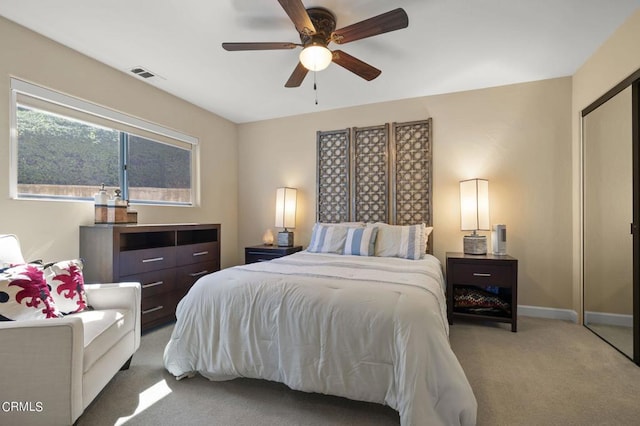 carpeted bedroom featuring ceiling fan and a closet