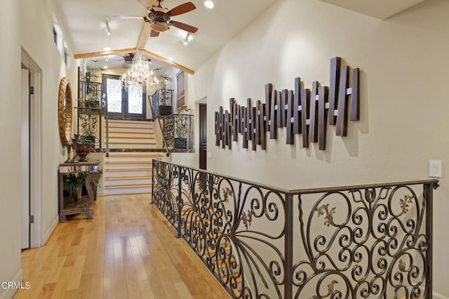 hallway featuring light hardwood / wood-style flooring and vaulted ceiling