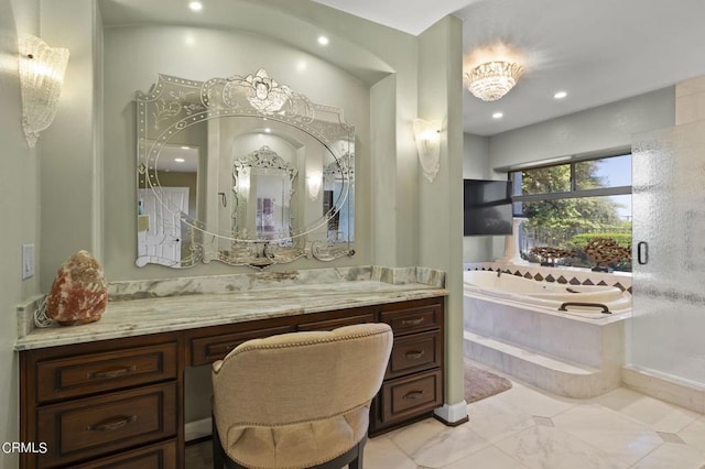 bathroom with vanity and tiled bath