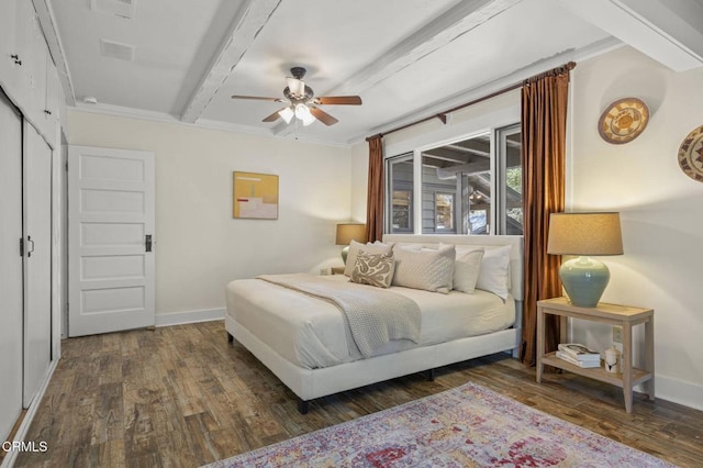 bedroom featuring dark wood-type flooring, ceiling fan, and beam ceiling