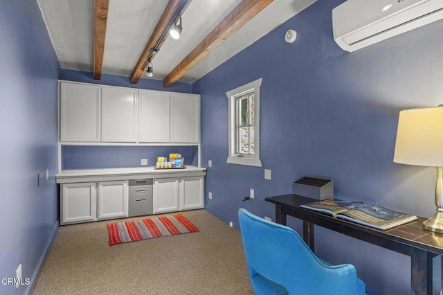 carpeted office featuring beam ceiling, track lighting, and a wall unit AC