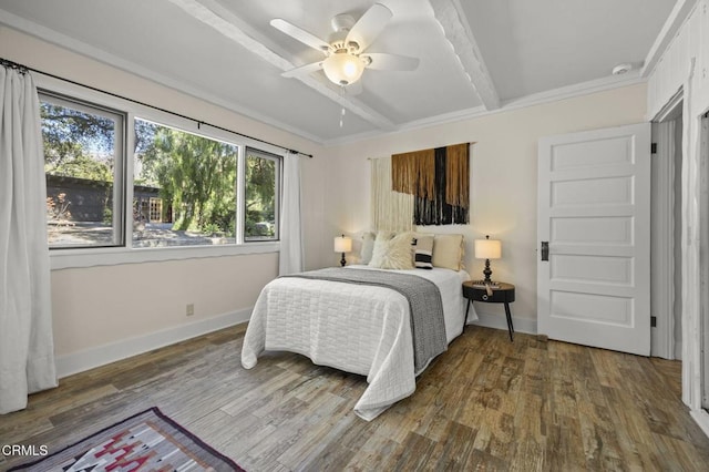 bedroom with ceiling fan, wood-type flooring, and beam ceiling