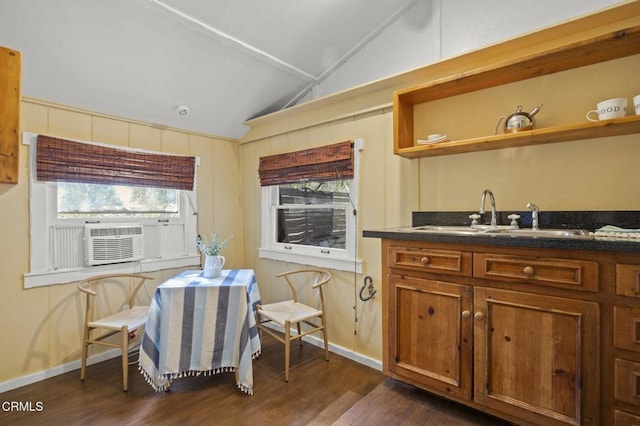 dining area with cooling unit, sink, vaulted ceiling, and dark wood-type flooring