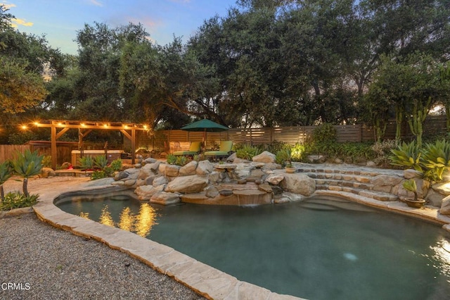 view of pool at dusk