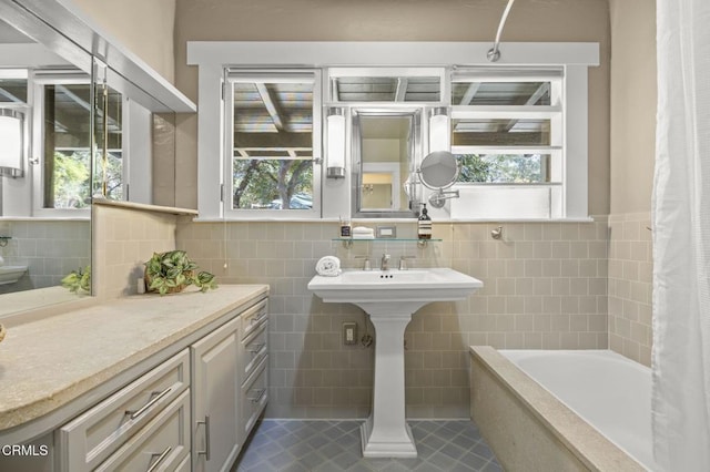 bathroom with shower / bath combination with curtain, tile patterned floors, and tile walls