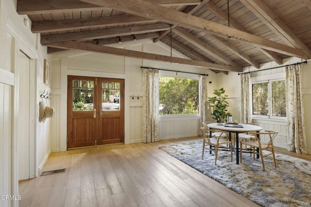 sunroom / solarium with vaulted ceiling with beams, a wealth of natural light, wooden ceiling, and french doors