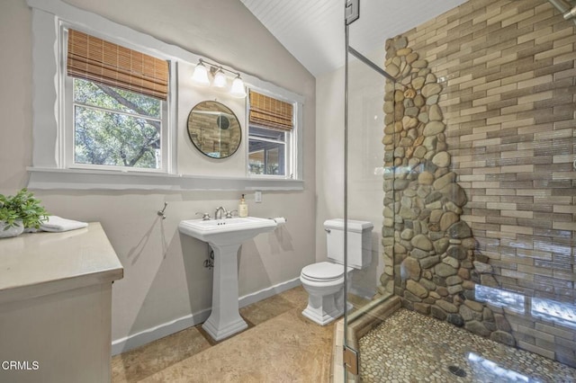 bathroom with lofted ceiling, sink, tile patterned floors, and toilet