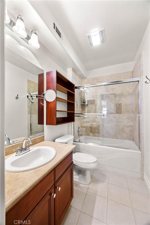 full bathroom with shower / bath combination with glass door, tile patterned floors, vanity, and toilet