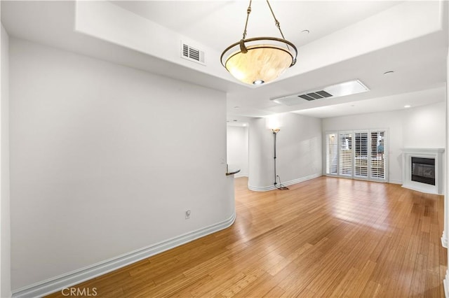 unfurnished living room with wood-type flooring