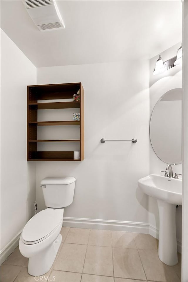 bathroom with tile patterned floors, sink, and toilet