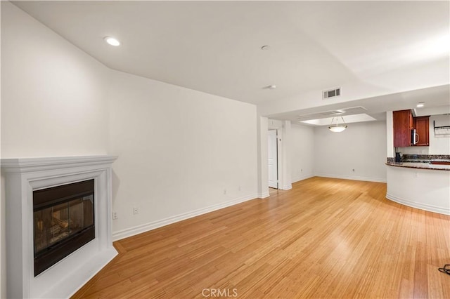 unfurnished living room with light hardwood / wood-style flooring