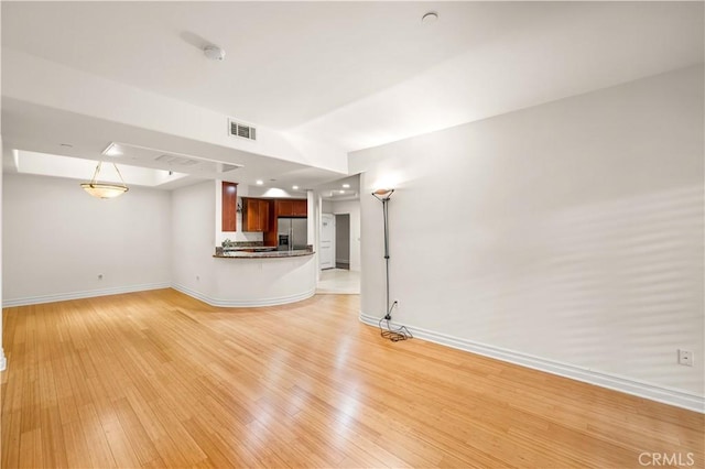 unfurnished living room with light wood-type flooring