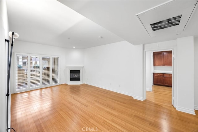 unfurnished living room with light wood-type flooring