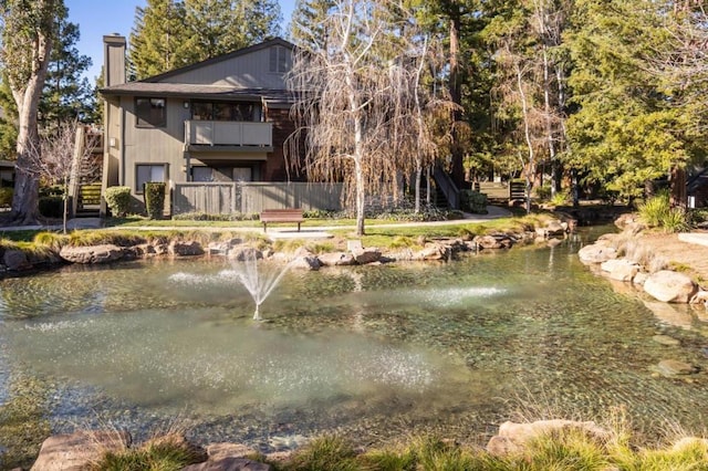 back of house featuring a water view