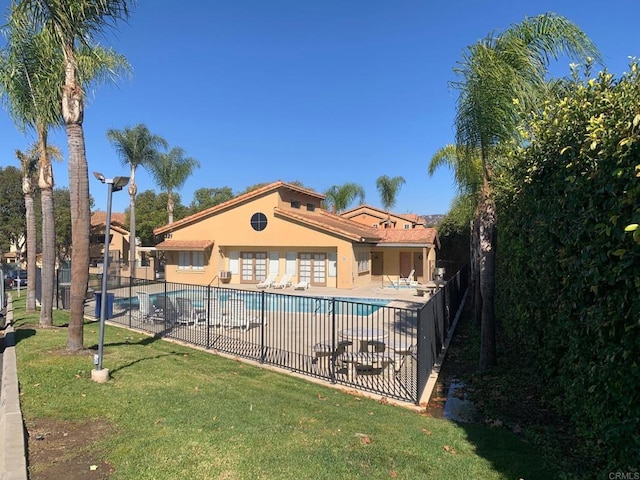 view of pool featuring a patio area and a yard