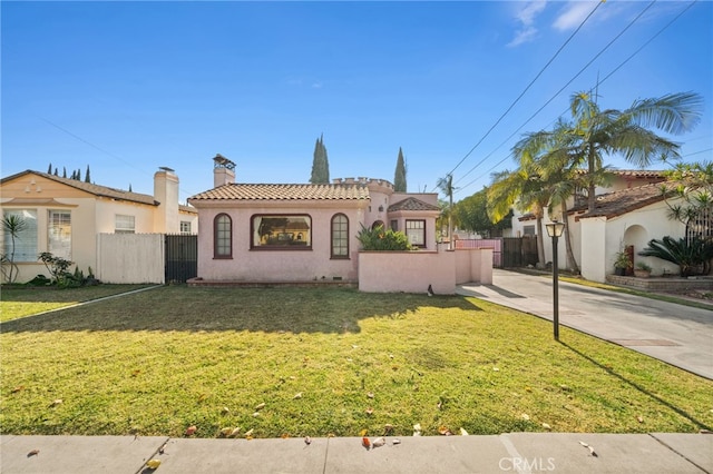 mediterranean / spanish home with a front yard