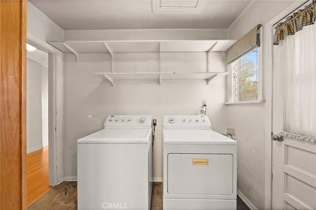 laundry area with independent washer and dryer and dark wood-type flooring