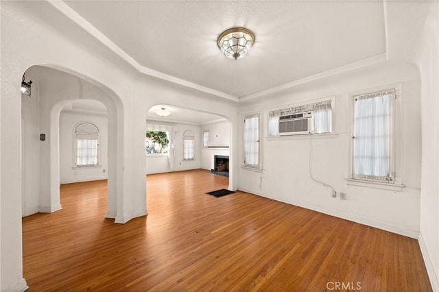 foyer entrance with a wall mounted AC and wood-type flooring