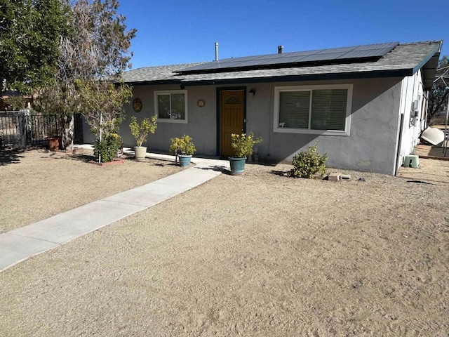 ranch-style house featuring solar panels