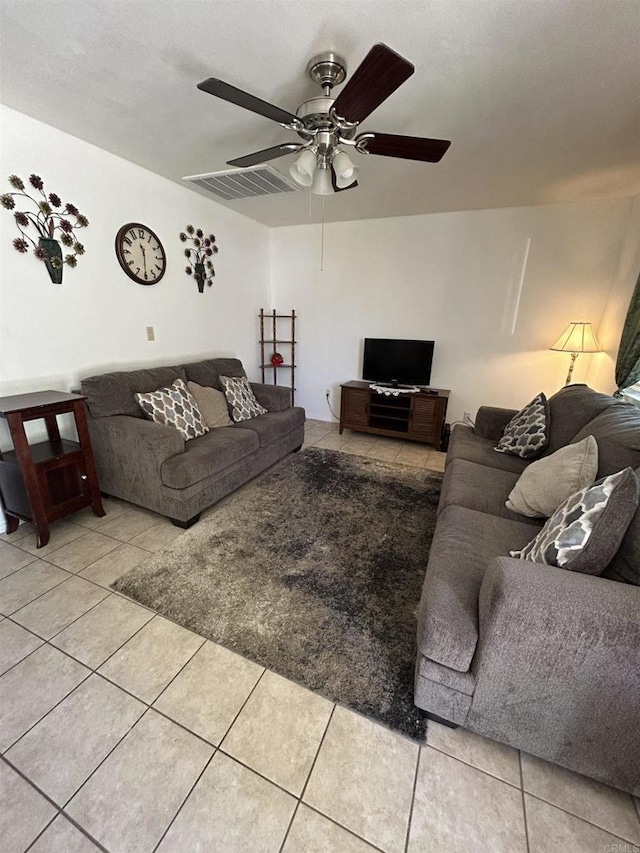 living room with ceiling fan and light tile patterned flooring