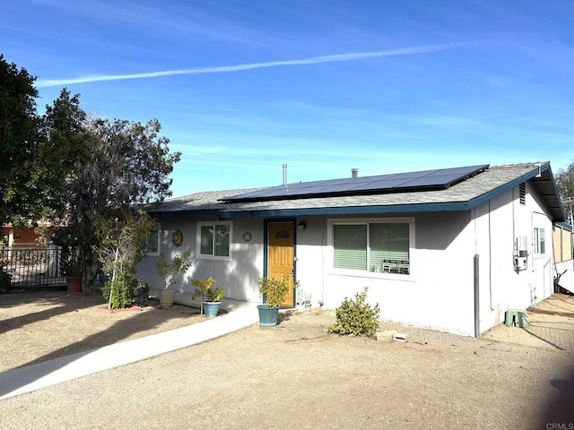 ranch-style house with solar panels