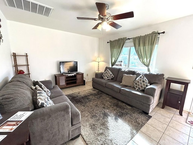 tiled living room with ceiling fan