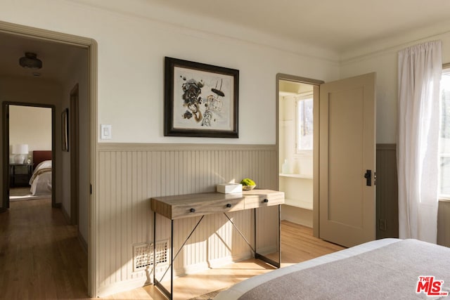 bedroom featuring hardwood / wood-style flooring and crown molding