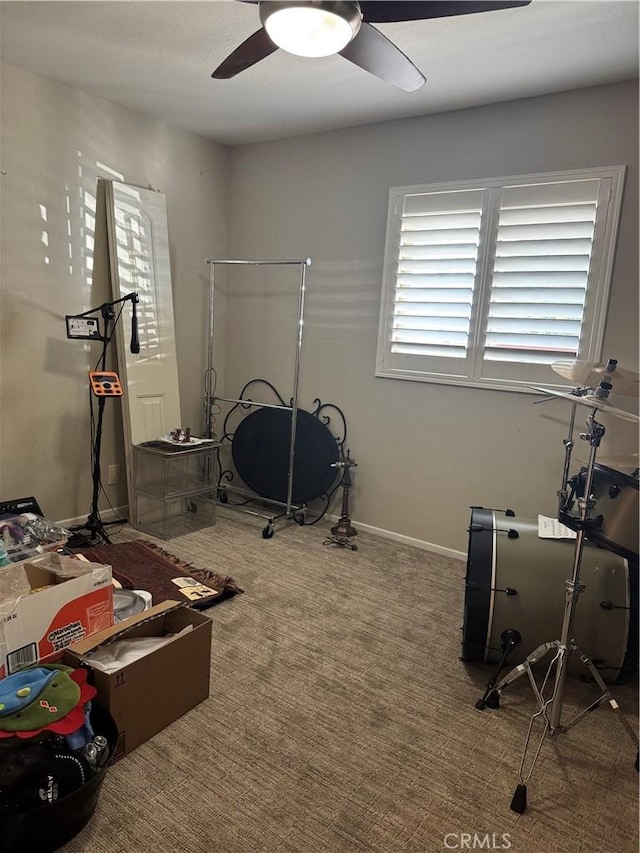 workout area featuring ceiling fan and carpet