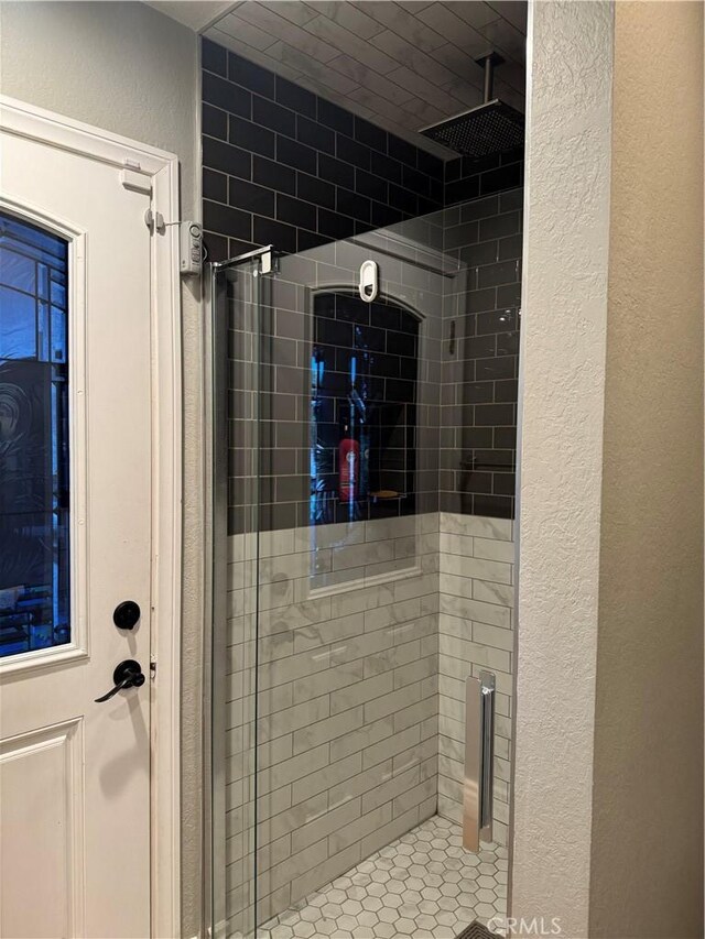 bathroom with tiled shower