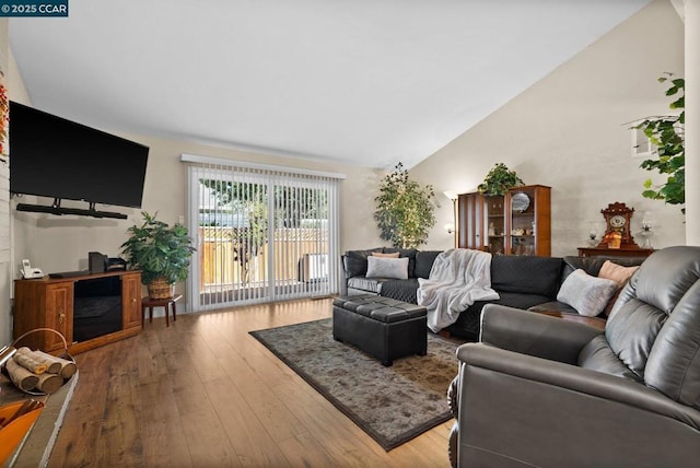 living room featuring vaulted ceiling and hardwood / wood-style floors