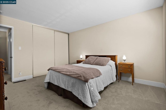 carpeted bedroom featuring a closet