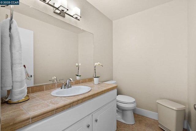 bathroom featuring tile patterned floors, toilet, and vanity