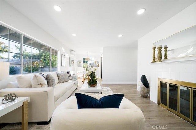 living room with light wood-type flooring and a fireplace