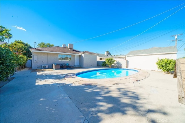 view of pool featuring a patio area and central AC unit