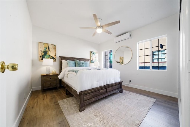 bedroom featuring ceiling fan, hardwood / wood-style floors, and a wall mounted air conditioner