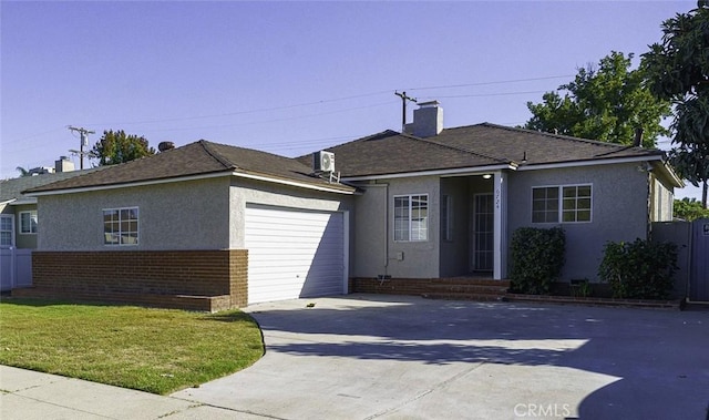 view of front of house with central AC unit, a garage, and a front yard