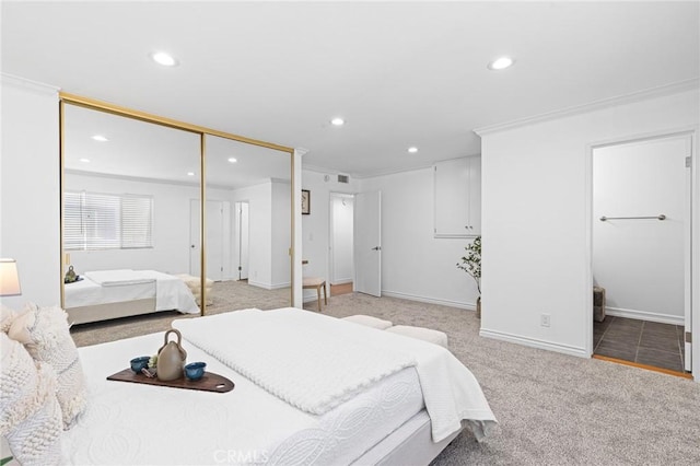 carpeted bedroom featuring crown molding and a closet