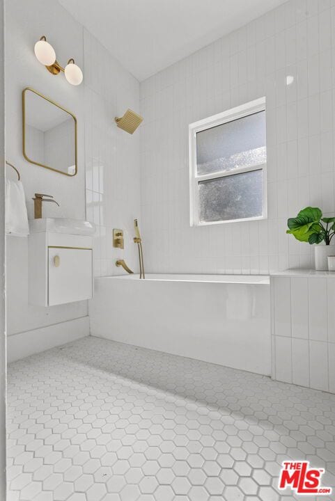 bathroom with tile patterned floors, sink, and bathtub / shower combination