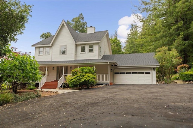 view of front of home featuring a porch and a garage